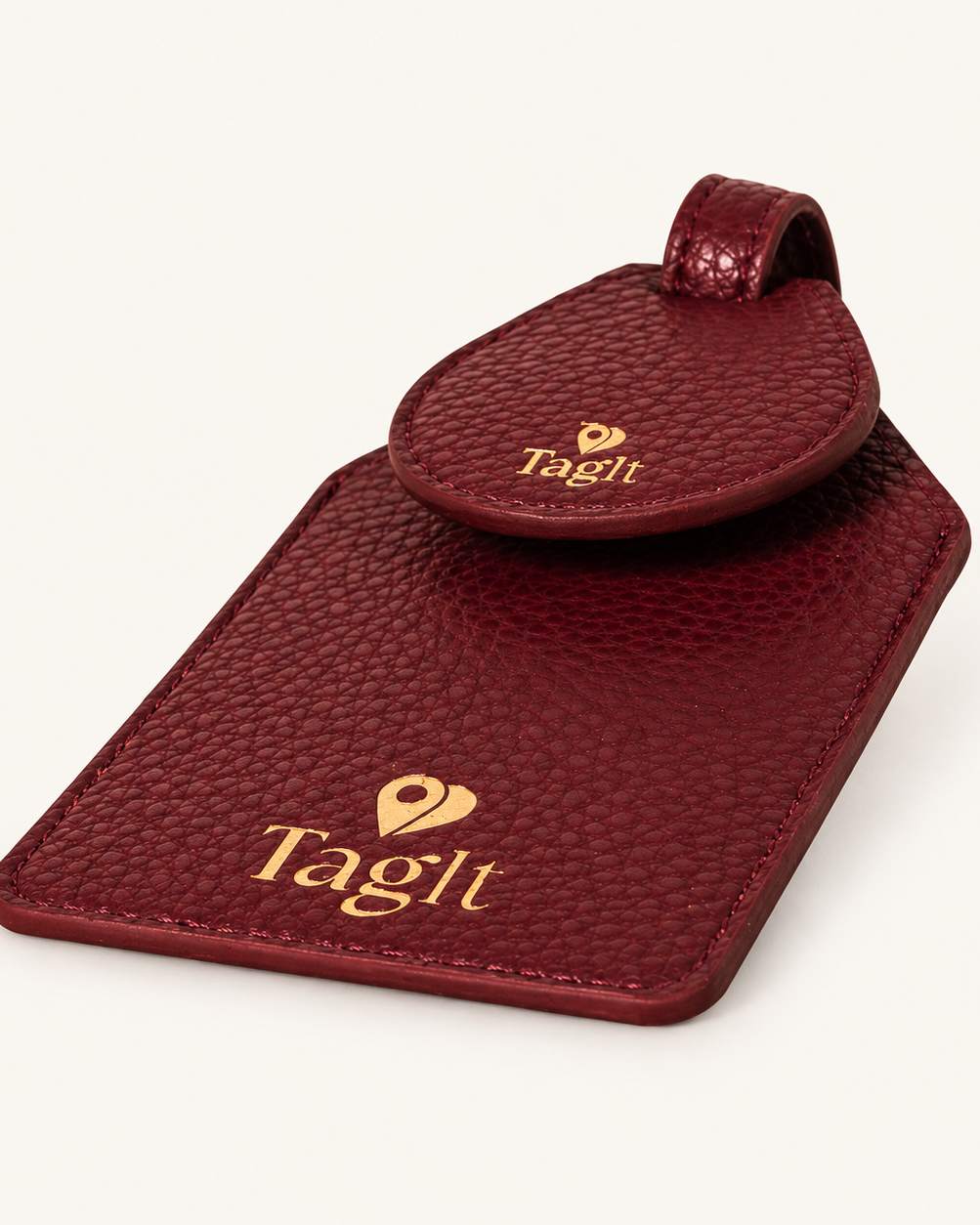 Wayfinder Vegan Pebble Leather AirTag Luggage Tag — Burgundy on soft ivory background