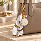 Keep Close AirTag Keychain — ivory — lifestyle on handbag — all-groups