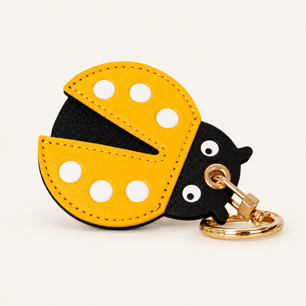 Little Explorer Universal Tracker Charm — Yellow Ladybug on soft ivory background