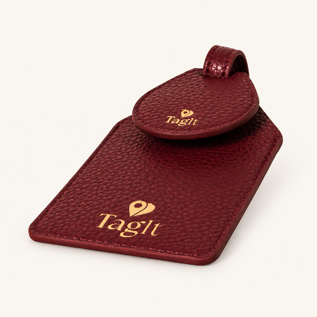Wayfinder Vegan Pebble Leather AirTag Luggage Tag — Burgundy on soft ivory background
